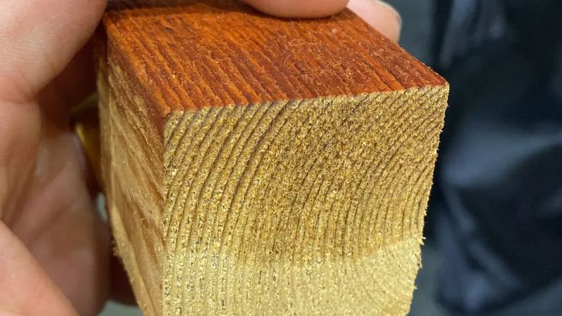 a close-up of a hand holding a square piece of wood